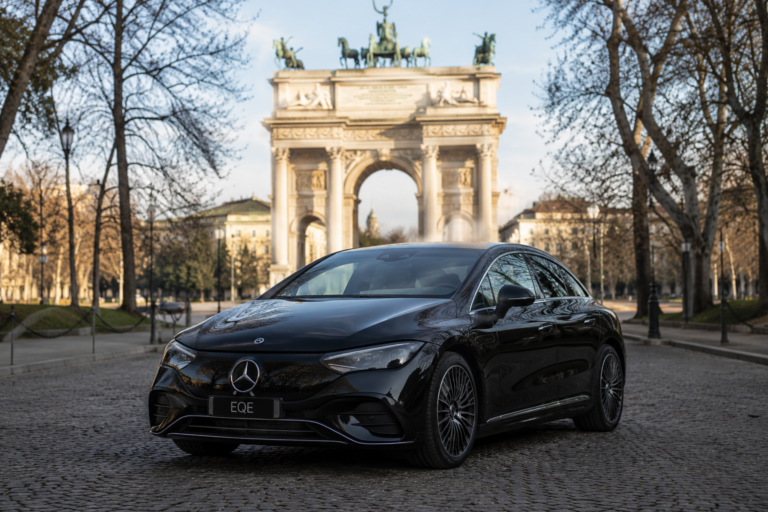 Electric Mercedes EQE chauffeur car in Milan near Arco della Pace for private luxury transfer service
