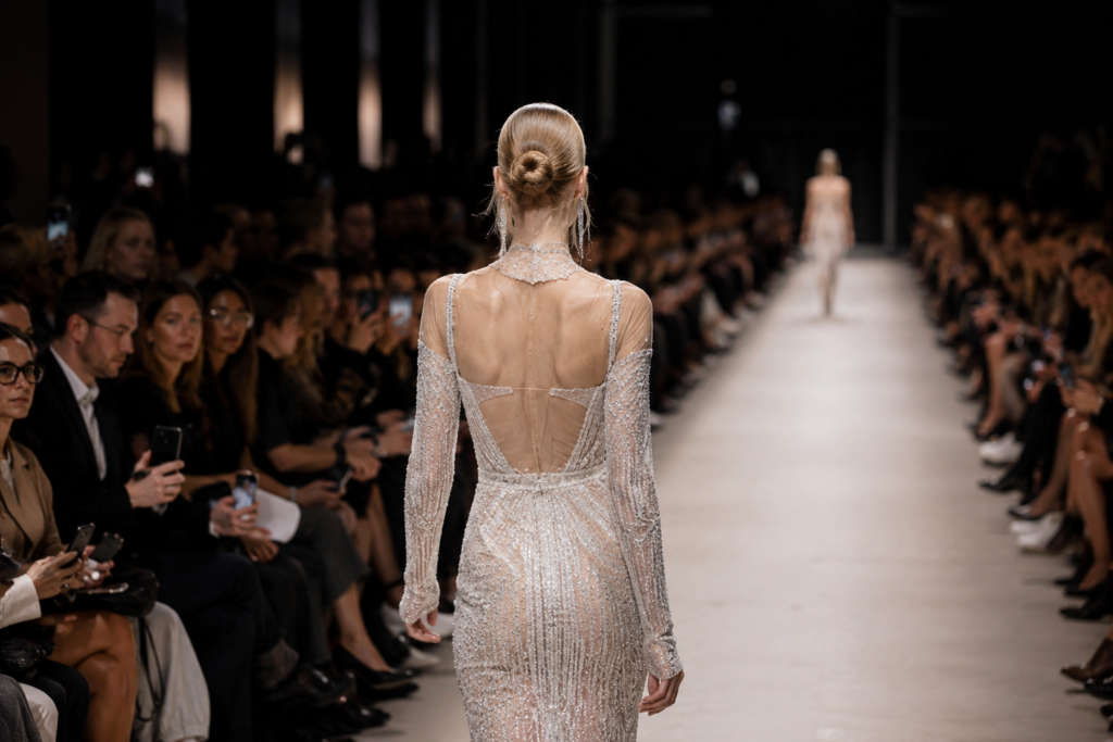Luxury fashion runway event inside a historic ballroom during an international high-profile fashion gathering in Milan.